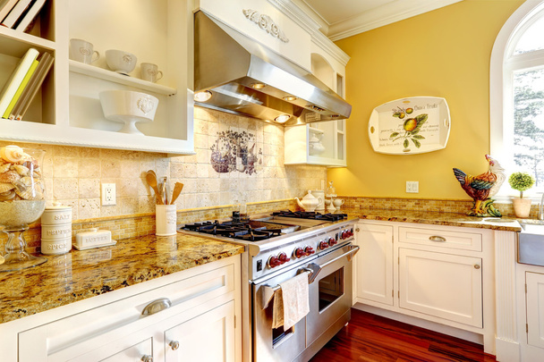 Bright yellow kitchen room with granite tops - Foto, imagen
