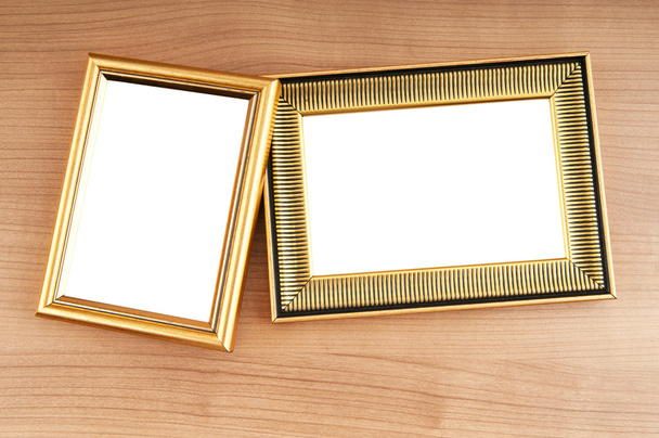 Picture frames on the polished wooden background - Φωτογραφία, εικόνα