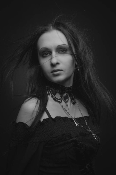 Beautiful gothic gil posing over dark background - Zdjęcie, obraz
