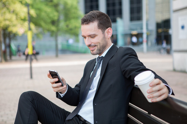 Businessman drinking a coffee during a break - Photo, Image