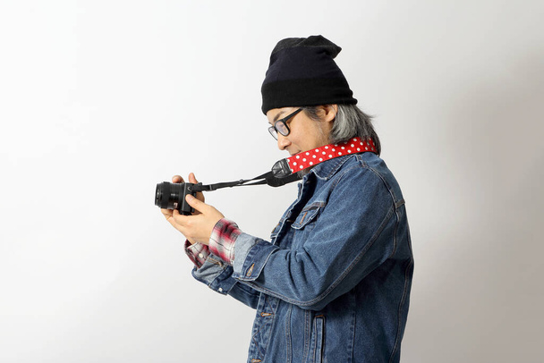 The Asian man with denim shirt and beanie standing on the white background. - Photo, Image