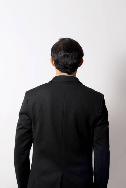 The Asian businessman on the white background. - Foto, afbeelding