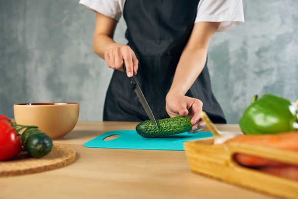 housewife on the kitchen cutting vegetables cutting board - Photo, Image