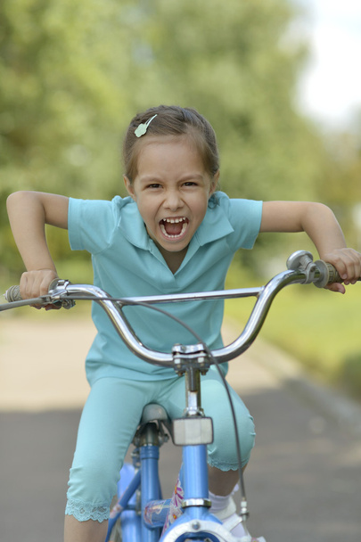 Happy girl on a bicycle - Photo, image