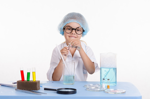 Девушка-химик открывает фляжку с реагентом
 - Фото, изображение