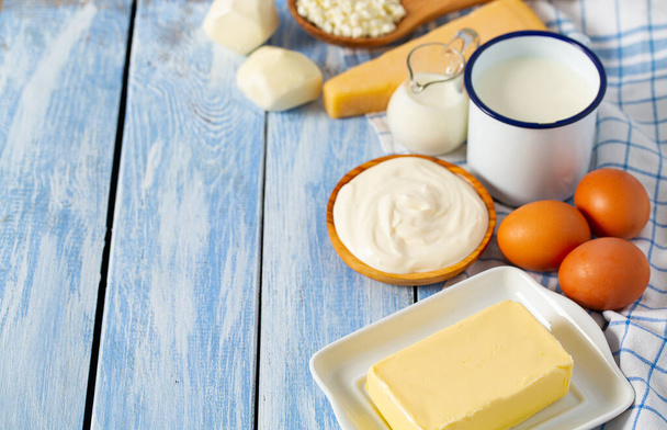 dairy products on blue wooden surface - Foto, Imagen