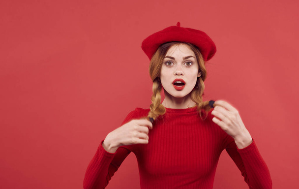 pretty woman in red hat holding hair charm fashion - Фото, изображение