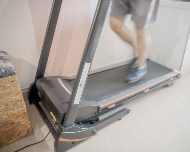 Motion of a Man running in a gym on a treadmill concept for exercising, fitness and healthy lifestyle - Photo, Image