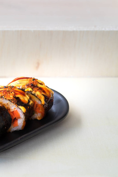 Korean food, gimbap or kimbap in a plate on a wooden background. - Photo, Image