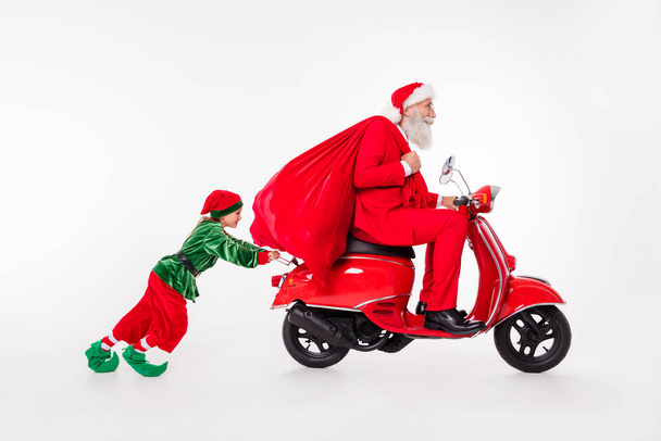 Profile side view of two nice cheerful people man riding motor bike carrying gifts kid helping pushing isolated over white color background - Fotoğraf, Görsel