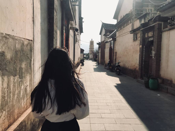 young woman in black dress walking in the city - Foto, imagen