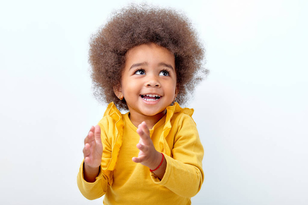 Cute african fluffy child girl clapping and applauding, happy and joyful, smiling - Fotografie, Obrázek
