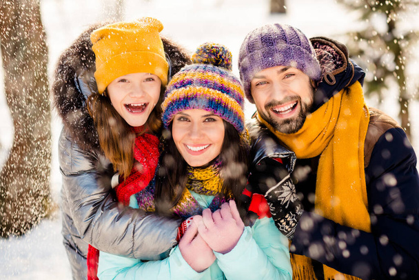 Photo of cheerful family of three happy positive smile hug cuddle embrace weekend fly air snow outdoors - Foto, afbeelding