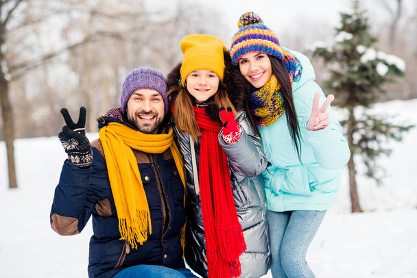 Photo of young family happy positive smile show peace cool v-sign hug cuddle embrace family trip outdoors - Foto, afbeelding
