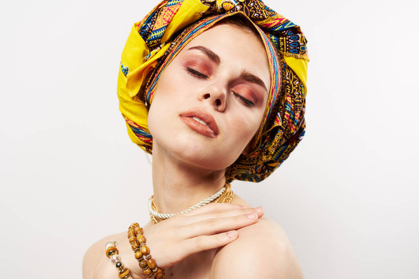 cheerful woman with multi-colored turban on her head decoration posing - Foto, Imagem