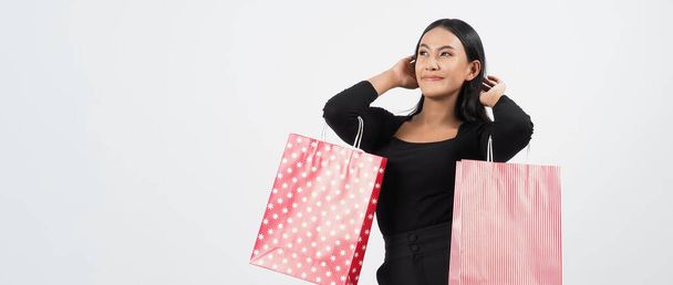 Woman shopping concept. Happily girl and shopping bags during sale season. Happy young asian Thai woman in action or activity of purchasing goods from stores or online shop and white background. - Photo, Image