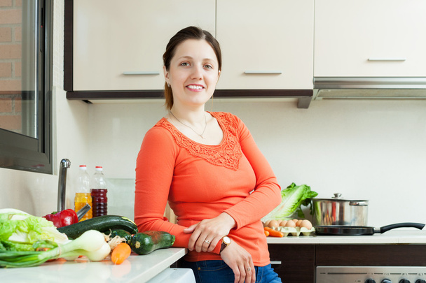 woman with fresh vegetables in  kitchen - Foto, Imagen