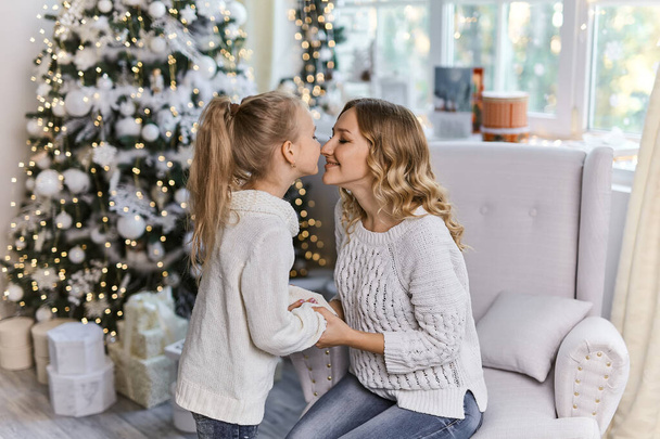 felice madre di famiglia e figlia bambino la mattina di Natale all'albero di Natale con regali - Foto, immagini