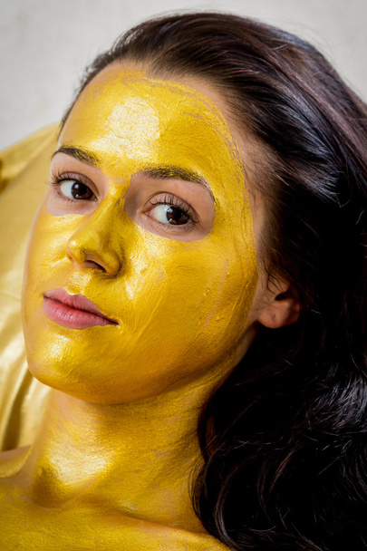 Woman in golden mask - Photo, Image