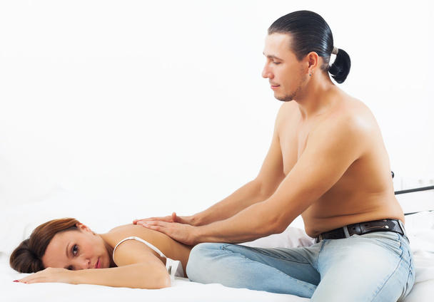 Husband massaging the back of his woman - Фото, зображення