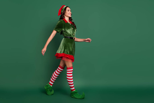 Full length body size view of attractive cheerful girl elf going festal occasion time isolated over green color background - Fotó, kép