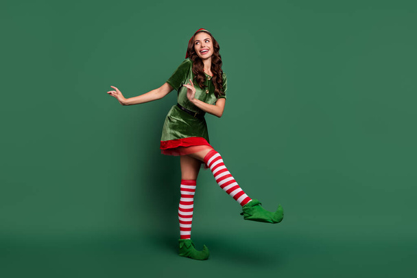 Full length body size view of attractive cheerful girl elf dancing having fun festal day event isolated over green color background - Valokuva, kuva