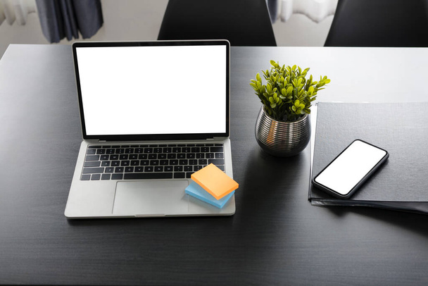 Computer laptop, sticky notes,  document and smart phone on office desk. - Zdjęcie, obraz