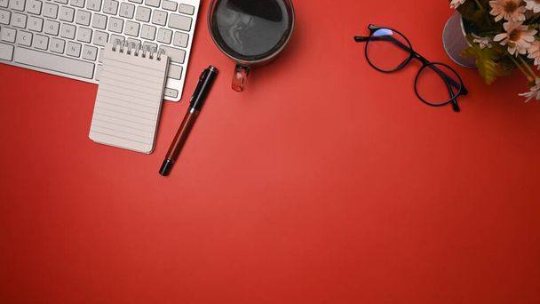 Cup of coffee, glasses and notebook on red background. - Photo, Image