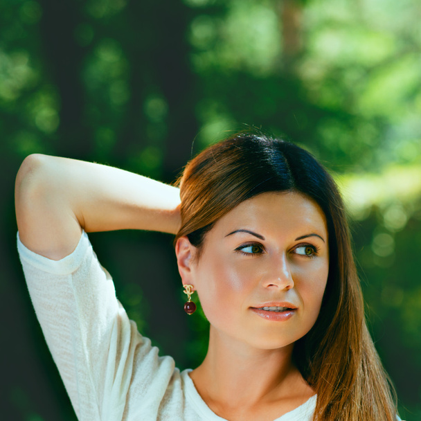 young woman  among green trees - Fotografie, Obrázek