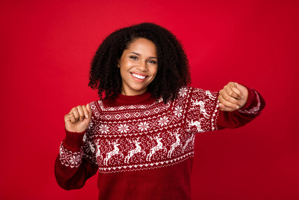 Photo portrait smiling girl happy in red pullover smiling dancing on xmas party isolated vivid red color background - Fotoğraf, Görsel
