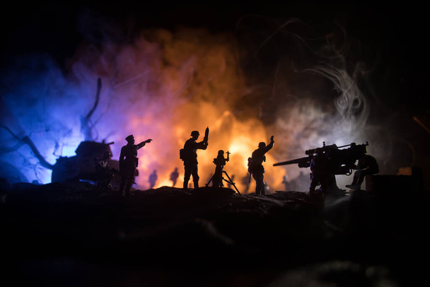 War Concept. Military silhouettes fighting scene on war fog sky background, World War Soldiers Silhouette Below Cloudy Skyline At night. Armored vehicle fight scene. Selective focus - Foto, Imagem