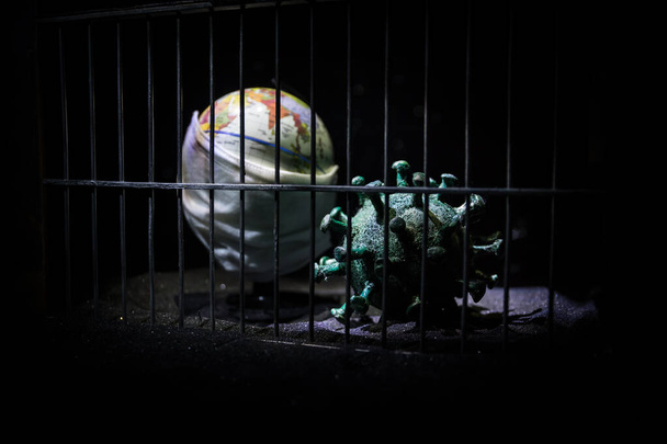 Corona virus lockdown creative concept. Planet earth trapped inside old prison. Creative artwork decoration. Selective focus - Photo, Image
