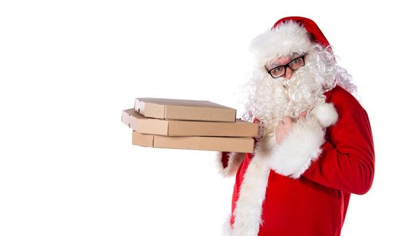 Funny Santa Claus is eating pizza. Hungry man. - Фото, изображение