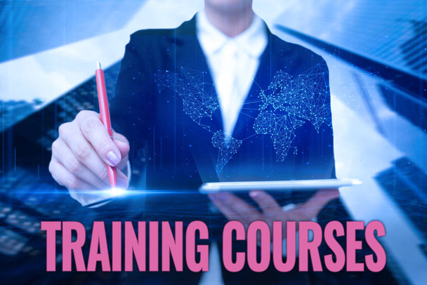 Hand writing sign Training Courses. Internet Concept is series of lessons or lectures teaching skills you need Lady In Uniform Standing Holding Tablet Typing Futuristic Technologies. - Photo, Image