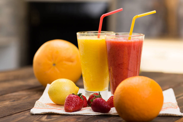 Fresh fruit smoothies on kitchen table in a two glass - Photo, Image