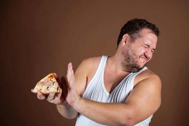 Diet and healthy lifestyle. Funny fat man with a burger. - Photo, image