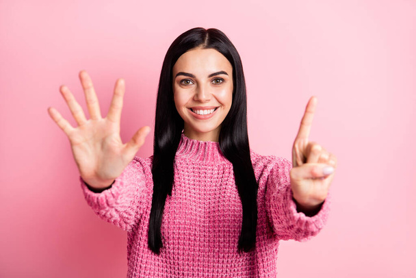 Photo of adorable person toothy smile arms fingers counting showing six isolated on pink color background - Foto, afbeelding