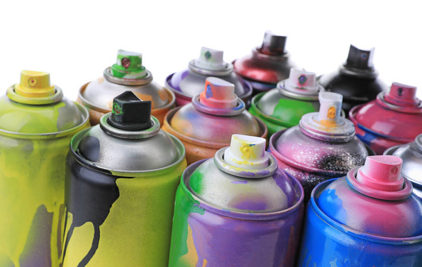 Used cans of spray paints on white background, closeup. Graffiti supplies - Fotografie, Obrázek