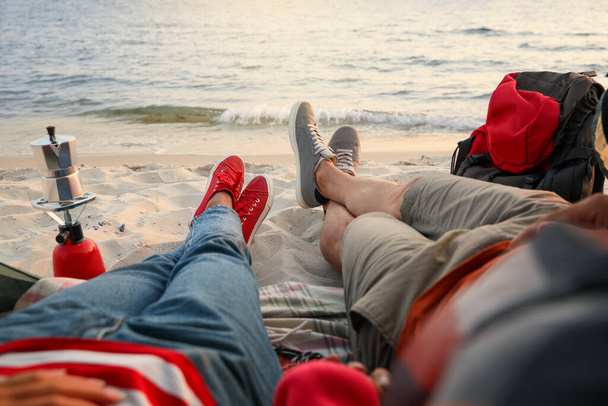 Couple resting near sea, closeup. Beach camping - Φωτογραφία, εικόνα