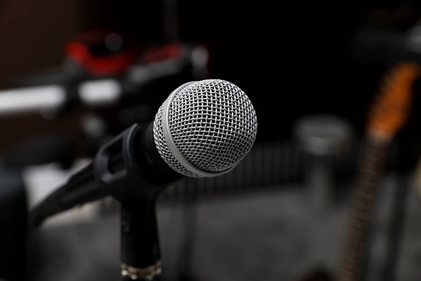 Modern microphone at recording studio, closeup with space for text. Music band practice - 写真・画像