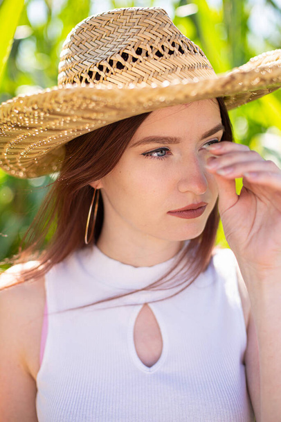 White european young girl in straw hat portrait - Photo, image