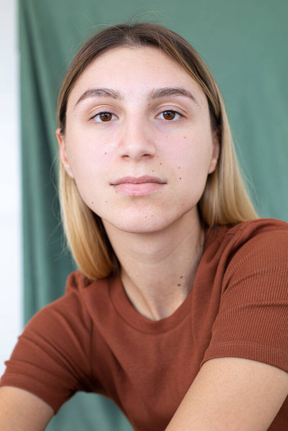 Portrait white girl with blonde hair partially green background in studio - Φωτογραφία, εικόνα