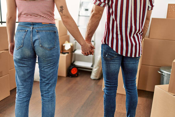 Couple on back view holding hands at new home. - Foto, afbeelding