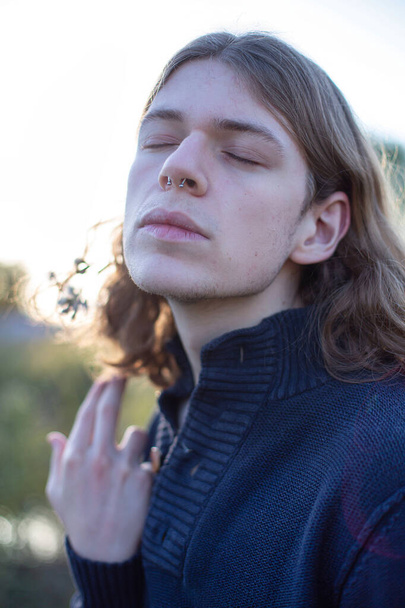 White european young man with long blonde hair portrait - Fotó, kép