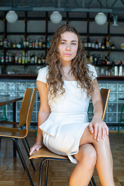 White european girl in white clothes in the restaurant - Fotoğraf, Görsel