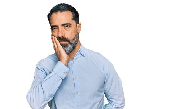 Middle aged man with beard wearing business shirt thinking looking tired and bored with depression problems with crossed arms.  - Foto, immagini