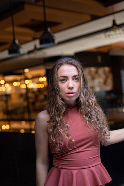 European girl with dark and curly hair in the restaurant - Fotó, kép