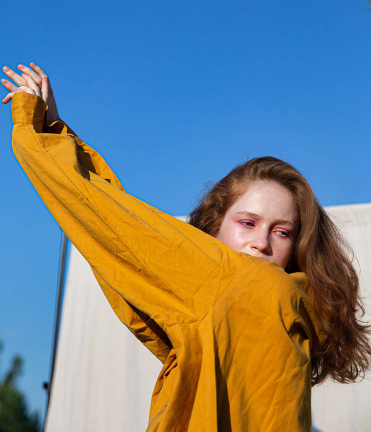 Young european white girl with dark hair in yellow clothes - Photo, image