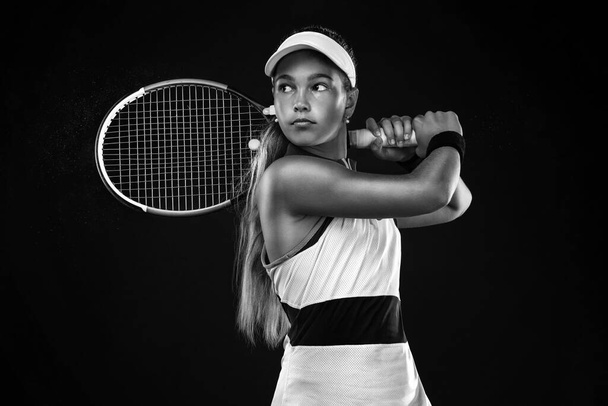 Tennis player. Beautiful girl teenager and athlete with racket in pink sporswear and hat on tennis court. Fashion and sport concept. - Fotoğraf, Görsel