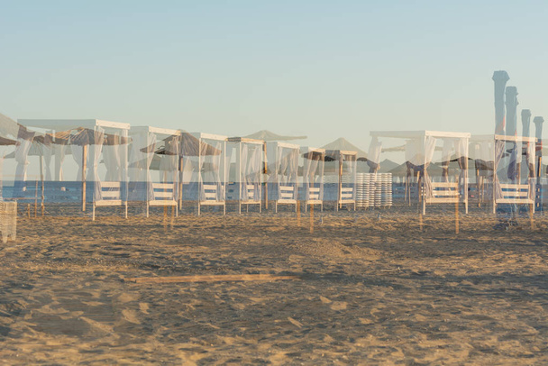 Zatoka, Odessa, Ukraine - September 1, 2021: Beach chairs and umbrellas shot with Photo mode special effect used: Multiple exposure - 写真・画像